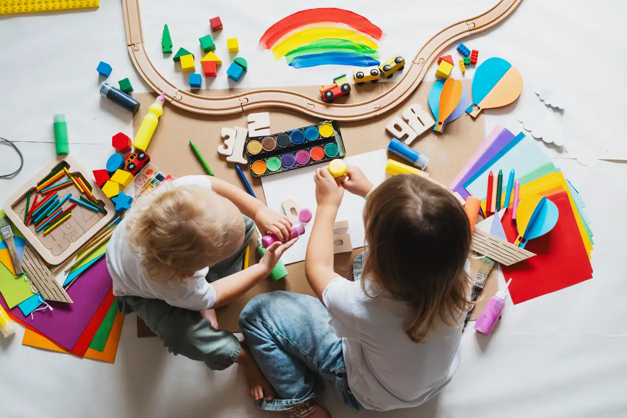 Children drawing and making crafts in kindergarten or daycare. Little kids with educational toys and supplies for creative. Сhildren education and development in preschool or childcare