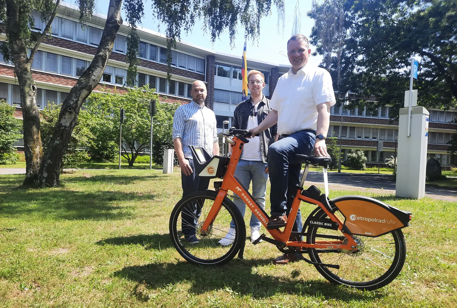 Dorstens Verkehrsplaner Gerrit Schweigart und Luca Hupperich sowie Bürgermeister Tobias Stockhoff mit einem Rad des Verleihsystems metropolradruhr.