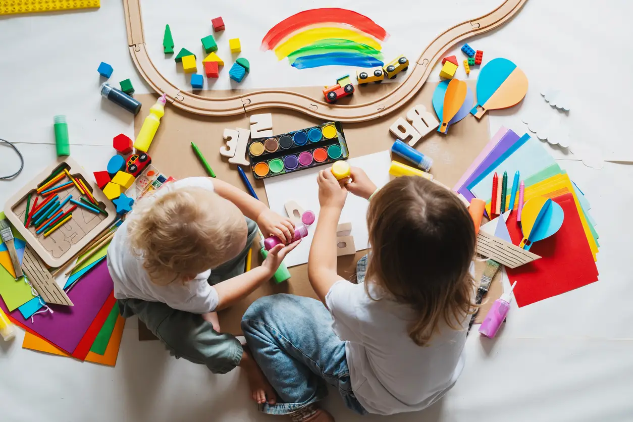 Children drawing and making crafts in kindergarten or daycare. Little kids with educational toys and supplies for creative. Сhildren education and development in preschool or childcare